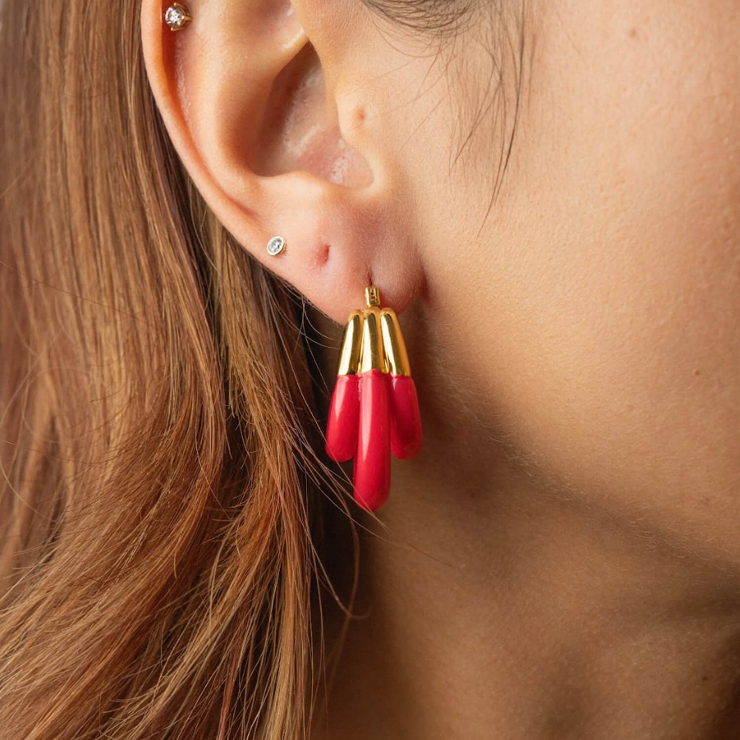 triple hoop earrings in gold and pink lucite