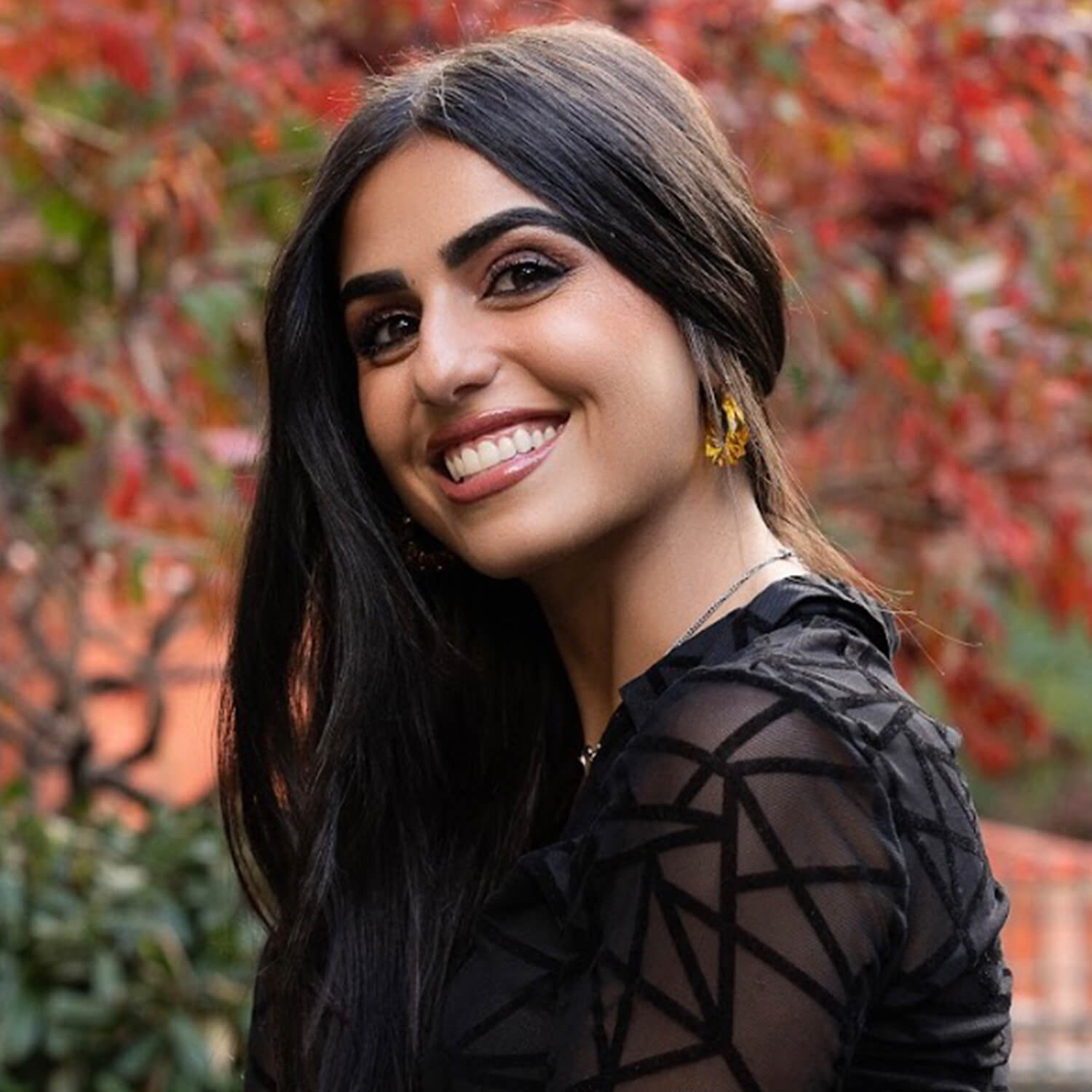 Purple hoop earrings with gold accents on a white background