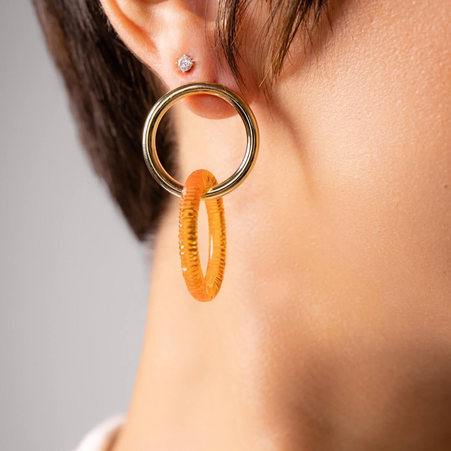 gold and lucite drop and dangle diamond cut earrings in clear