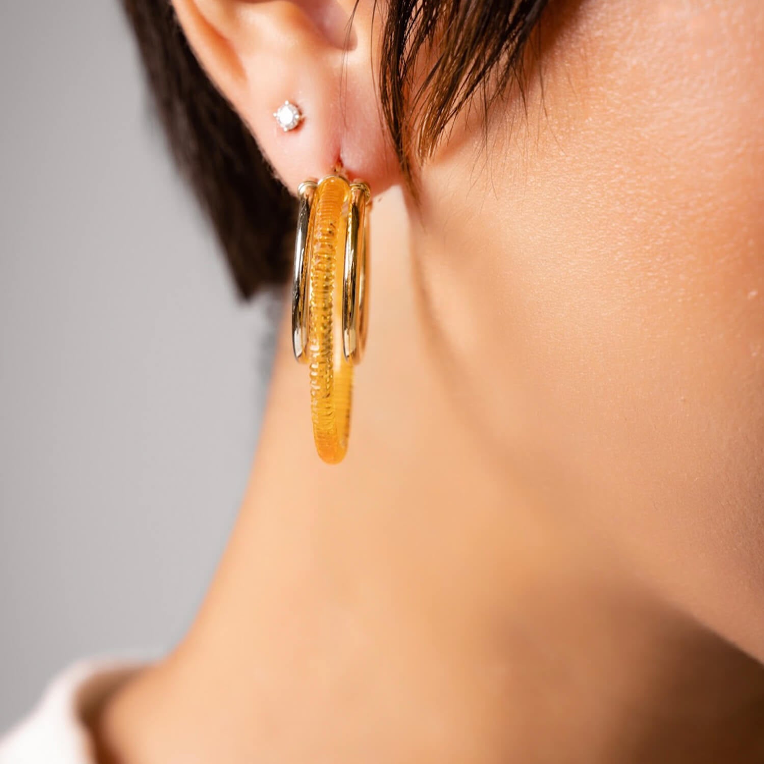 triple multi gold hoop earrings in honey orange gold lucite